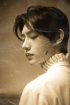 an old photo of a woman with her hair pulled back and wearing a collared shirt