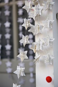 some paper stars hanging from the side of a building