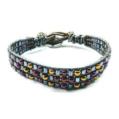 Men's ruggedly handsome and trendsetting earth-tone beaded leather wrap bracelet, crafted with hematite, brass and bronze-hued intricate needle work. Boasting a Tree of Life button loop closure fitting up to 8- 9 inches wrist, it's an essential accessory for any dapper man. Bracelet designed for men Loved by women also Earth Colored Beadwork Features macrame sections Triple row beaded bracelet Tapered beaded ends Unique one of a kind look Rustic yet elegant Tree of Life Button Closure Wear it to Adjustable Metal Wrap Bracelet Hand Wrapped, Adjustable Metal Hand-wrapped Bracelet, Adjustable Hand Wrapped Metal Wrap Bracelet, Adjustable Brown Hematite Beaded Bracelets, Adjustable Hand Wrapped Metal Beaded Bracelets, Adjustable Hematite Beaded Bracelets In Bohemian Style, Mens Tree, Elephant Clothes, Puzzle Piece Necklace