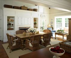 a dining room with wicker chairs and a table