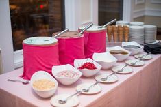 there are many bowls and spoons on the table ready to be served at an event