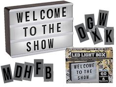 the words welcome to the show are lit up in black and white letters, along with an ad for led light box