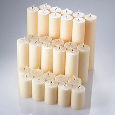 many white candles are lined up together