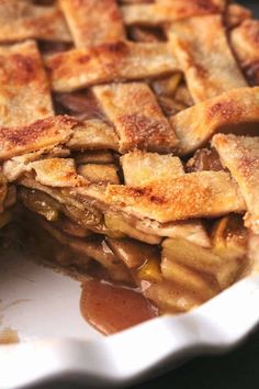 an apple pie sitting on top of a white plate