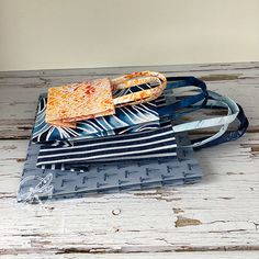 three pieces of fabric sitting on top of each other in front of a wooden table