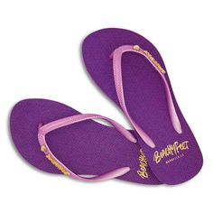 Built for the beach, Styled for the Sun, Meet your new dance partner. Beachyfeet® are the summer essential for your suitcase. The women's collection comes with a slimmer strap and features the brand's soft and slinky footbed. Pasión Púrpura is a gorgeous deep purple beach basic design. The sole print features Art Deco detailing and the strap is embellished with the brand's gold BeachyFeet® pin. A bold and contrasting model, these flip flops can be paired with ease together with deeper summer ton Adjustable Purple Flip Flops For Summer, Purple Summer Sandals For The Beach, Trendy Purple Sandals For The Beach, Purple Summer Beach Sandals, Purple Flip Flops For Spring Beach Outings, Adjustable Purple Sandals For Beach, Purple Sandals For Beach Vacation, Adjustable Purple Sandals For Vacation, Purple Sandals For Vacation And Beach Season