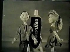 two dolls are standing next to each other in front of a bottle that says bicycle