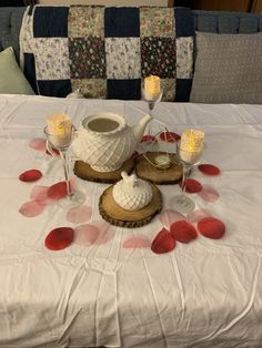 the table is set with candles and teapots