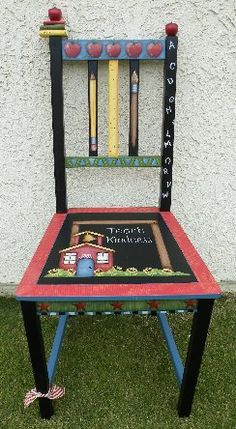 a child's chair made out of crayons and pencils is sitting in the grass