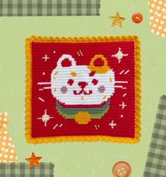 a close up of a cat on a patch of cloth