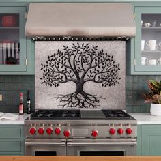 a kitchen stove top with a metal tree on it's back splashing paint