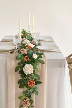 the table is decorated with flowers and candles