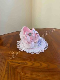 a small pink hat sitting on top of a wooden table