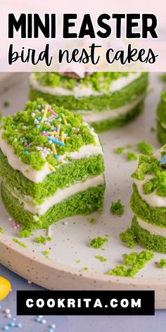 green cake with white frosting and sprinkles on top, sitting on a plate