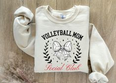 Are you a proud volleyball mom looking to show off your team spirit? Look no further! This volleyball Mom Social Club Shirt is the perfect addition to your wardrobe. Whether you're cheering on your little athlete on the sidelines or hanging out with other sports moms, this shirt is a must-have. Made with high-quality materials, it is comfortable to wear all day long. Get yours today and let everyone know you're part of the ultimate volleyball mom squad!  Ideal for any situation, a unisex heavy b Volleyball Mom Shirts, Volleyball Mom, Club Sweatshirts, Club Shirts, Sports Mom, Social Club, Mama Shirt, Mom Shirt, Team Spirit