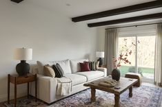 a living room filled with furniture and a large window