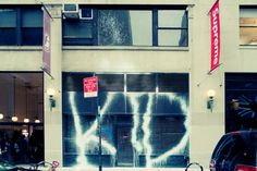 cars parked in front of a building with graffiti on it