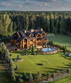 an aerial view of a large house with a pool in the yard and tennis court