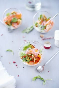 three small bowls filled with food on top of a table