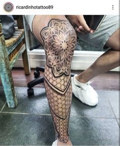 a man's leg with an intricate tattoo on it