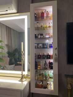 a lighted medicine cabinet in the corner of a living room with a mirror and shelves