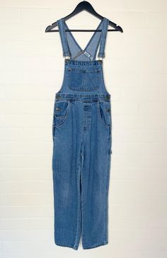 Vintage 1990s 'Pooh' medium wash long denim overalls.  In excellent vintage condition.  Fabric: Cotton Size: 6 Australian   Measurements  Length: 144cm (adjustable) Waist: 70cm Hips: 90cm Rise: 34cm Follow us on Instagram @cultofvtg 90s Style Denim Jumpsuit With Pockets, 90s Style Blue Denim Overalls, Vintage Light Wash Denim Overalls, 90s Style Denim Overall Jumpsuit, 90s Denim Overall Jumpsuit, Vintage Light Wash Overalls With Pockets, 90s Style Denim Overalls With Pockets, Vintage Style Medium Wash Denim Shortalls, 90s Denim Overalls With Pockets