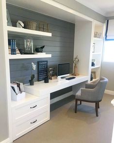 a desk with a chair, computer monitor and bookshelf in a home office