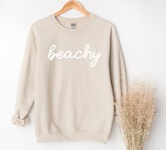 Whether you are taking a sunset stroll on the beach or lounging at home, this beachy sweatshirt will bring you pure comfort.  This unisex heavy blend crewneck is made from polyester and cotton, helping the design come out looking fresh and beautiful. The collar is ribbed knit, so it retains its shape even after washing. There are no itchy side seams on these sweaters. 50% Cotton 50% Polyester Medium-heavy fabric Unisex sizes (See size chart.) Sewn in label Available in 4 colors. Explore all Summ Cotton Sweatshirt With Letter Print, Relaxed Fit Cotton Beach Sweatshirt, Cotton Sweatshirt For Beach Vacation, Cotton Sweatshirt For Beach Season Vacation, Beach Cotton Crew Neck Sweatshirt, Casual Beach Sweatshirt, Trendy Crew Neck Sweatshirt For Beach, Crew Neck Sweatshirt For Beach In Spring, Casual Beach Season Sweatshirt