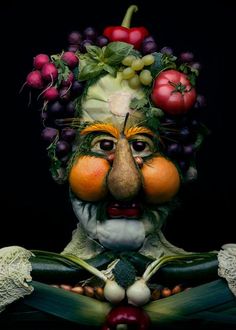 a man made out of fruits and vegetables wearing a face mask on top of his head