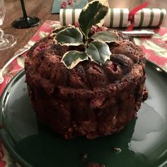 a chocolate cake sitting on top of a green plate