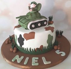 a birthday cake decorated with a tank on top