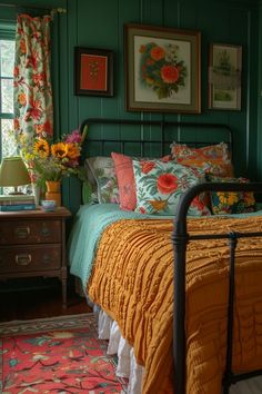 a bed room with a neatly made bed and pictures on the wall