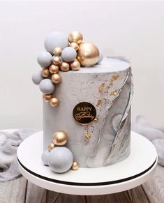 a white cake with gold and silver decorations