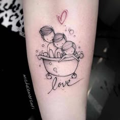 a couple sitting in a bathtub with the word love tattooed on their arm and behind them