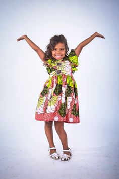 Are you tired of dresses that are nice to look at but just don't seem to provide much use? What about pieces that your little one grows out of before you can make full use of them. Yes, I know that experience too well which is why our Artisans in Nigeria and I created the Elisa design girl dress. Complementary bloomers included for size 12 months and 2T The dress is made out of the softest cotton fabric It has an elastic waist and adjustable ruffled tie on the back that is not only stylish but w Whimsical Short Sleeve Dresses For Playtime, Playful Green Dress For Dress-up, Whimsical Multicolor Short Sleeve Dress, Whimsical Multicolor Cotton Dress, Fun Green Short-sleeved Dresses, Fun Green Short Sleeve Dress, Green Fun Dresses With Ruffles, Simple African Dresses, African Dress Patterns