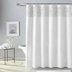 a white shower curtain in a bathroom