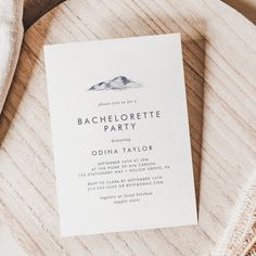 a close up of a paper with a mountain in the background on a wooden table