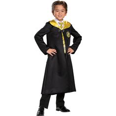 a young boy dressed in a harry potter costume with his hands on his hips and smiling at the camera