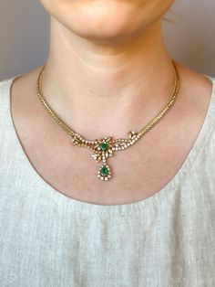 *Art Nouveau Necklace *14k Gold *Emerald, Genuine *Diamond, Natural *Emeralds, 0.85 carats *0.90 carat diamonds, 2.60 carats total  *17 inches *Circa 1960s ☞ Some fine jewelry items may show patina or signs of age or wear in photos. Rest assured, your jewelry will be carefully cleaned and polished prior to shipping! If you would like the natural patina left on, send us a note! Quality You Can Trust *Authenticated by a GIA Graduate Gemologist  *Detailed Quality Control and Careful Restoration *5 Green Diamond Necklace For Formal Occasions, Formal Green Hallmarked Diamond Necklace, Vintage Yellow Gold Diamond Necklace For Formal Occasions, Classic Hallmarked Emerald Necklace For Wedding, Classic Emerald Necklace For Wedding, Classic Wedding Emerald Necklace Hallmarked, Classic Wedding Emerald Necklace, Emerald Necklace In Yellow Gold For Weddings, Yellow Gold Emerald Necklace For Wedding