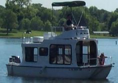 a white boat with people on it in the water