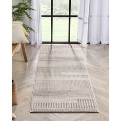 a white rug in front of a window