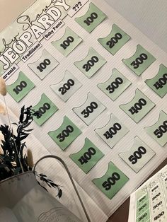 a bunch of green stickers sitting on top of a table next to a potted plant