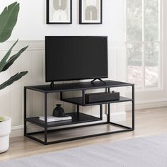 a black tv stand in front of a white wall