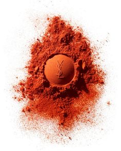 an orange powdered container with the word y on it is surrounded by red dirt