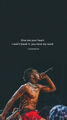 a man with no shirt on holding a microphone in front of his face and the words give me your heart i won't break it, you have my word