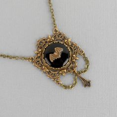 "This brass filigree and black glass necklace will add a touch of Victorian Gothic charm to your outfit. It would make a fabulous gift for any bat lover. 💀 DESCRIPTION: This elegant Y necklace features a small bat stamping that was hand set onto a vintage jet black cabochon. It was set into a lace edge setting and then layered onto an ornate filigree with Fleur de Lis detailing. The filigree is adorned with chain and an Art Deco style drop. The cable chain was finished with a lobster clasp and Bat Pendant, Flying Bat, Skull Purse, Crow Skull, Brass Filigree, Victorian Goth, Y Necklace, Metal Girl, Pet Necklace