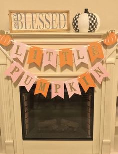 a little pumpkin bunting banner hanging over a fireplace