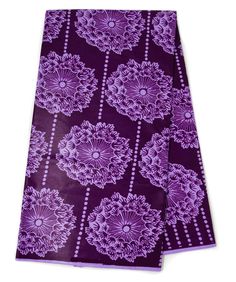 two napkins with purple flowers on them, one is folded and the other has an intricate