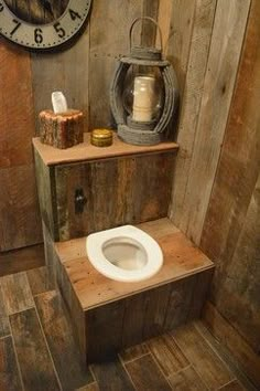 there is a toilet in the corner of this bathroom with wood walls and flooring