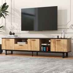 a living room with a large flat screen tv mounted on the wall and wooden furniture